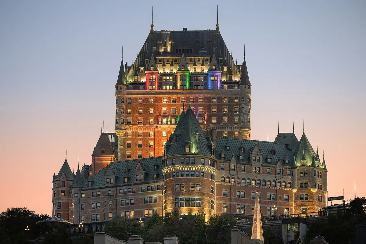 The Château Frontenac lit up against a pink dusk sky in Quebec City