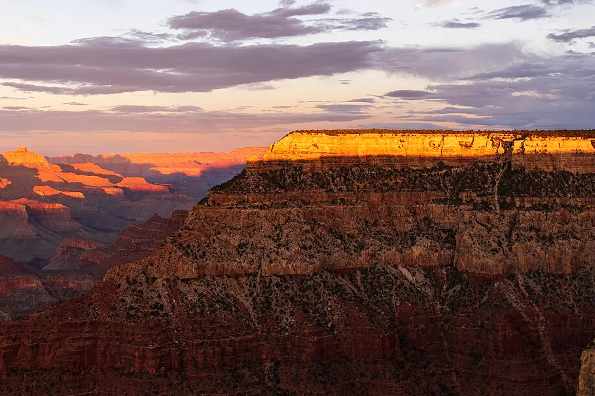 Sunset light on the red rock walls of the Grand Canyon