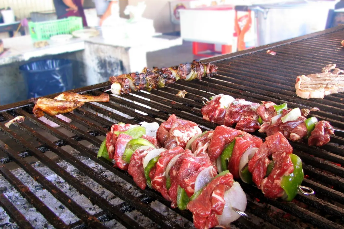 Beef and pepper skewers cooking on a barbecue grill