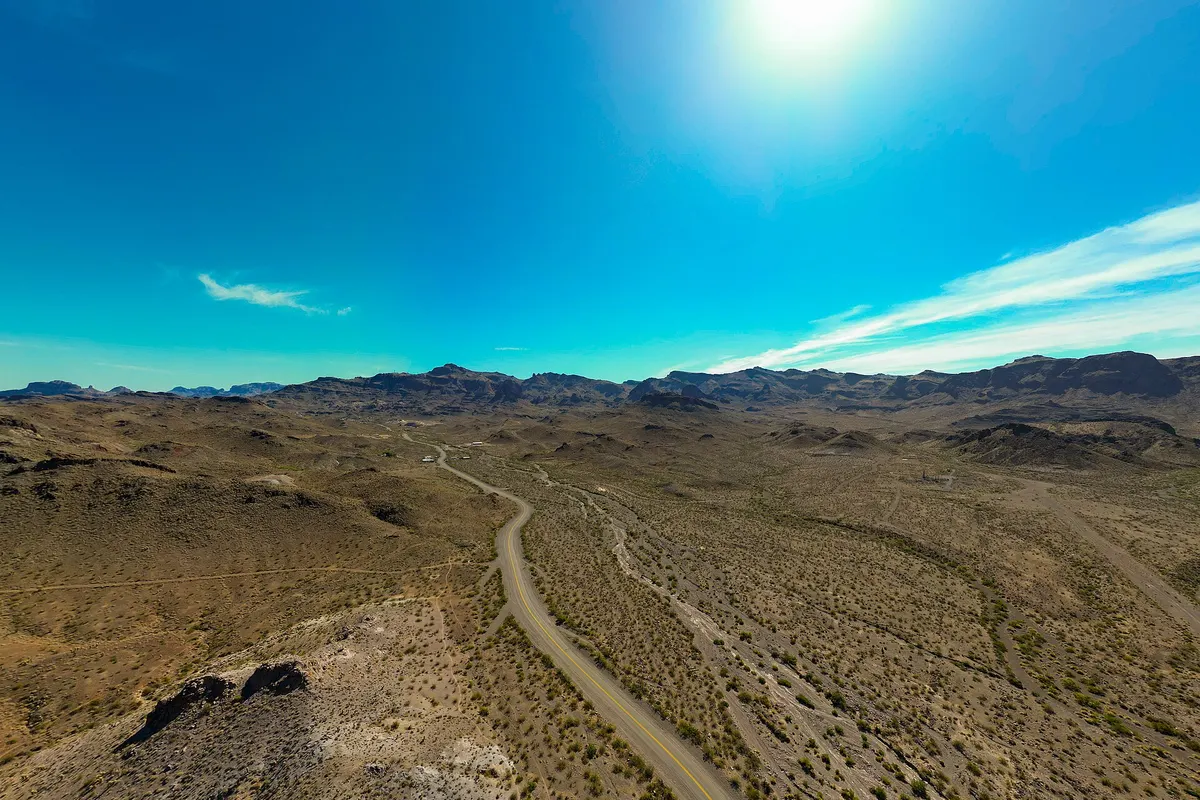 Route 66 winding through the dry Black Mountains near Oatman, Arizona, under a blue sky