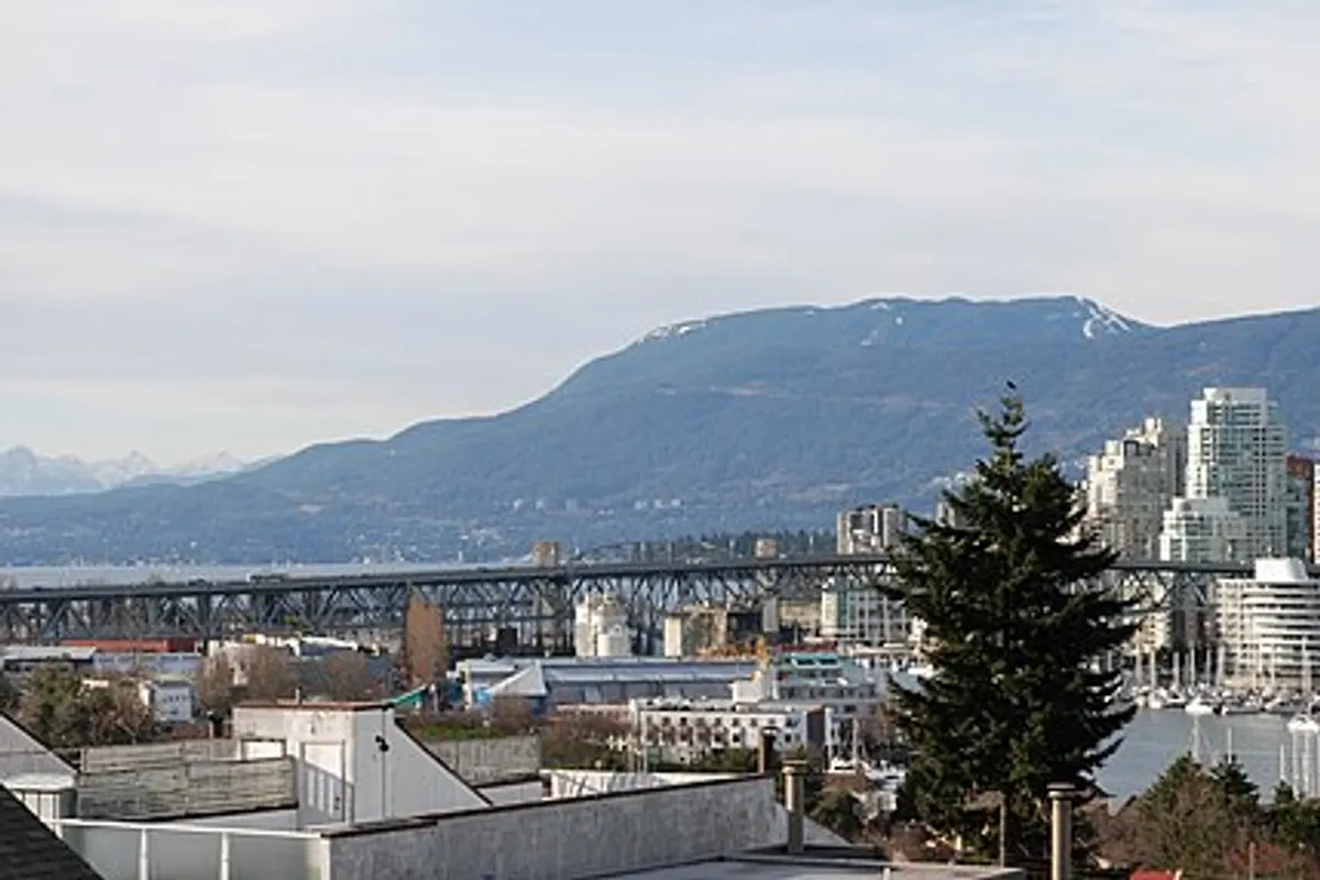 Vancouver’s downtown towers along False Creek with snow-capped North Shore mountains behind